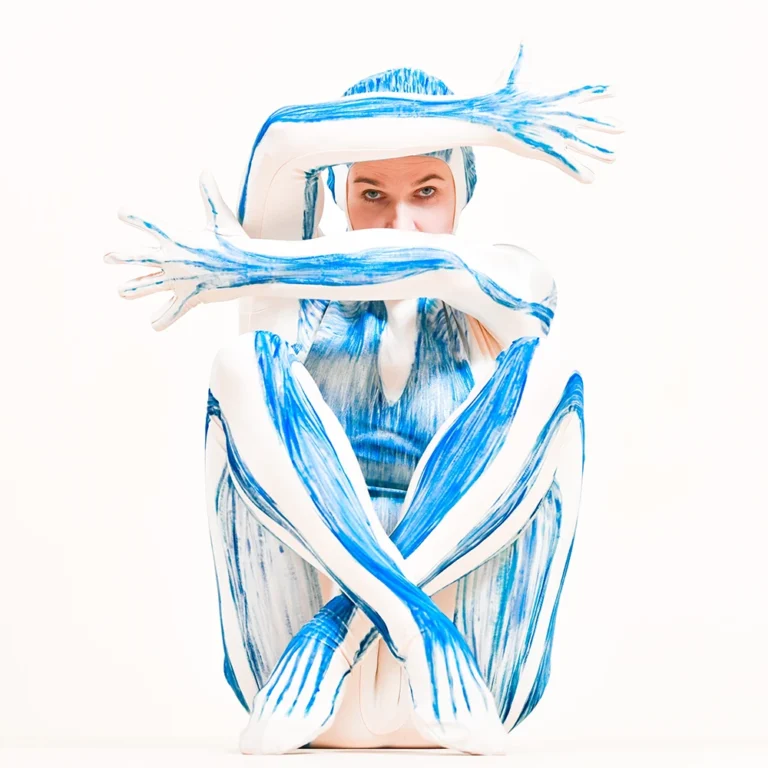 Patrycja Adaszewska w białym stroju z niebieskimi elementami podczas warsztatu Powięziówka.